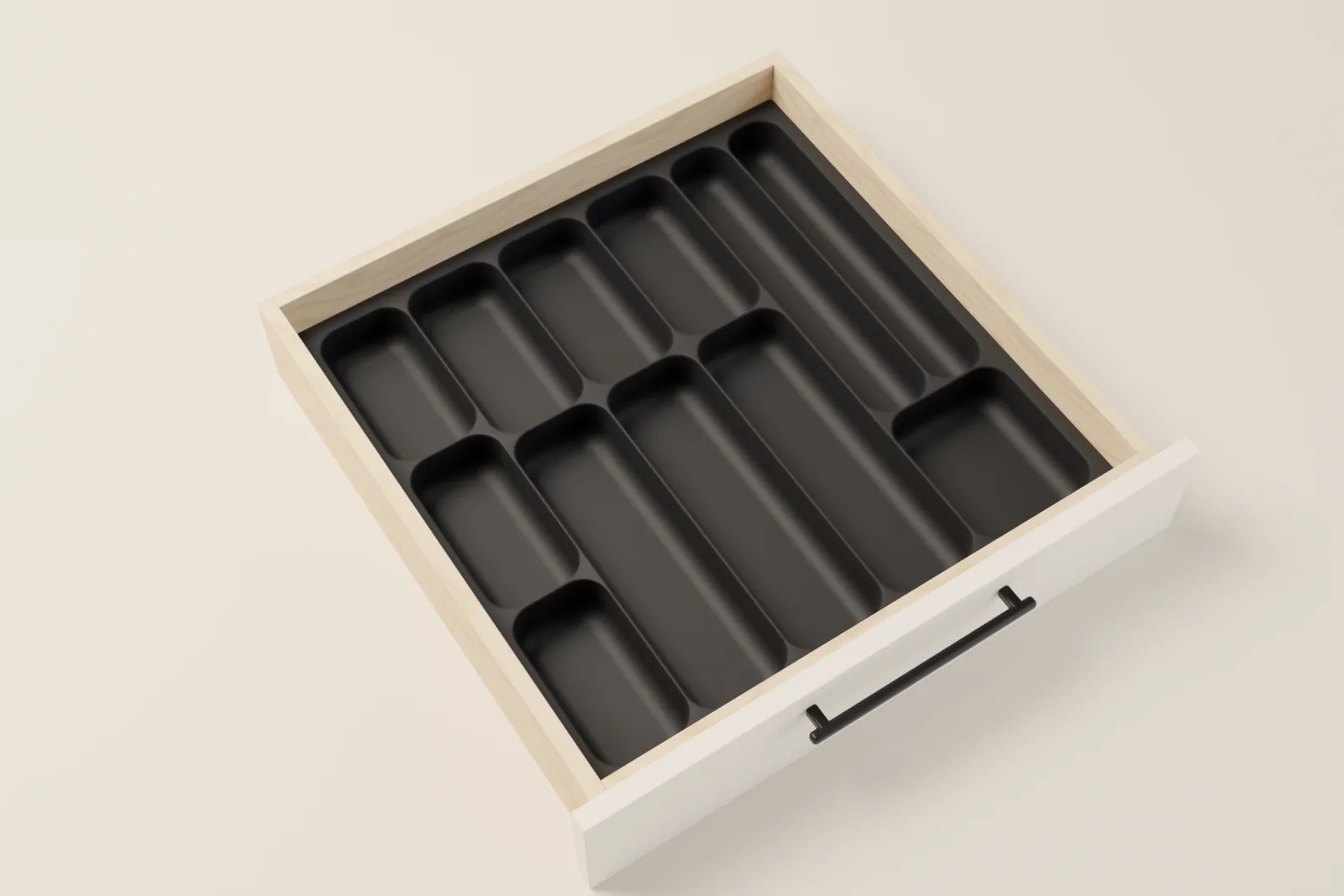 A black organizer set filling a kitchen drawer wall to wall