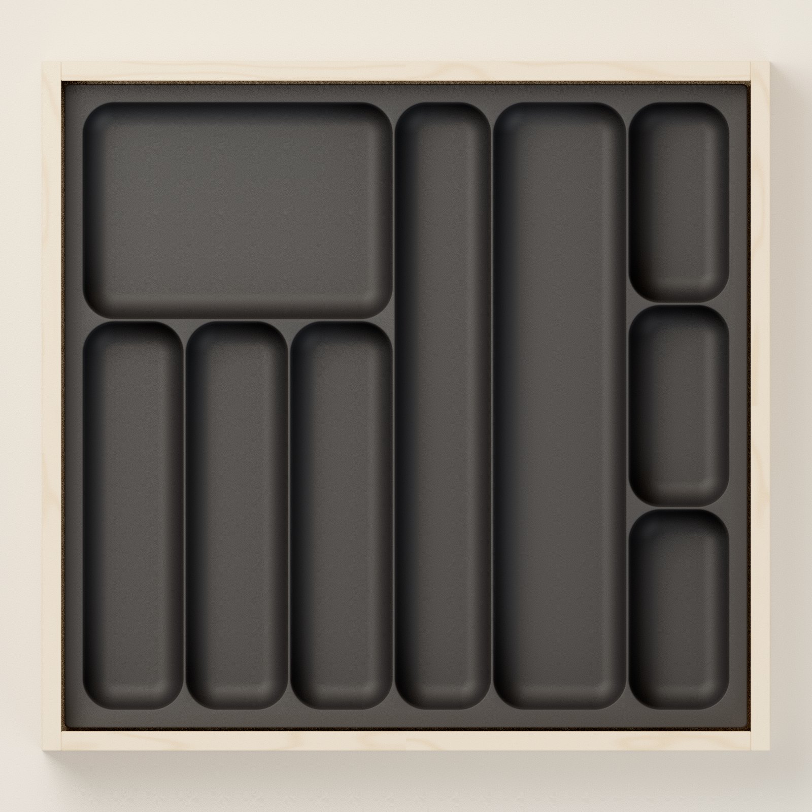 Top view of a black Tryambak organizer: cutlery slots, a long knife lane, a wide spatula lane and small boxes